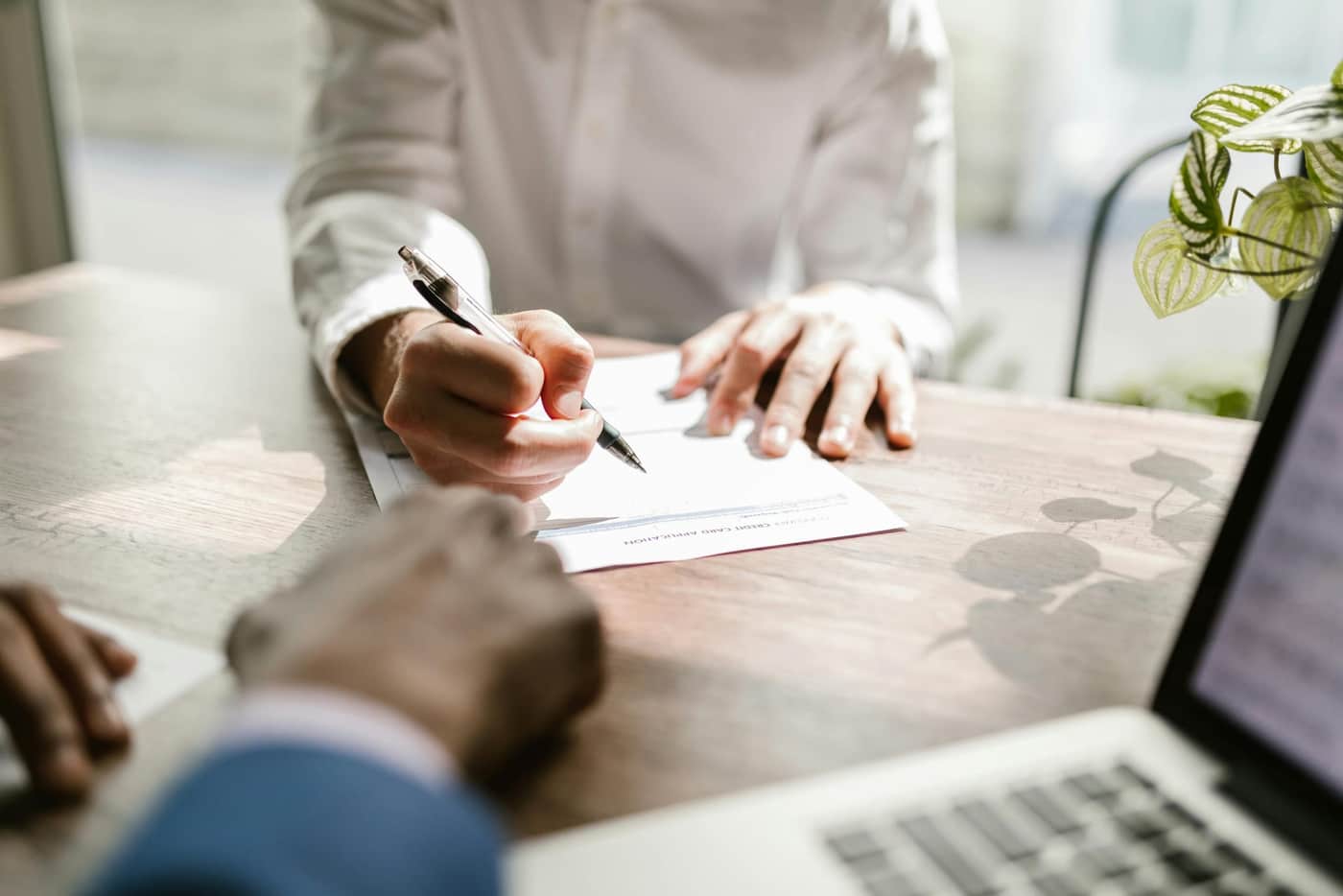 Signing a document at a desk
