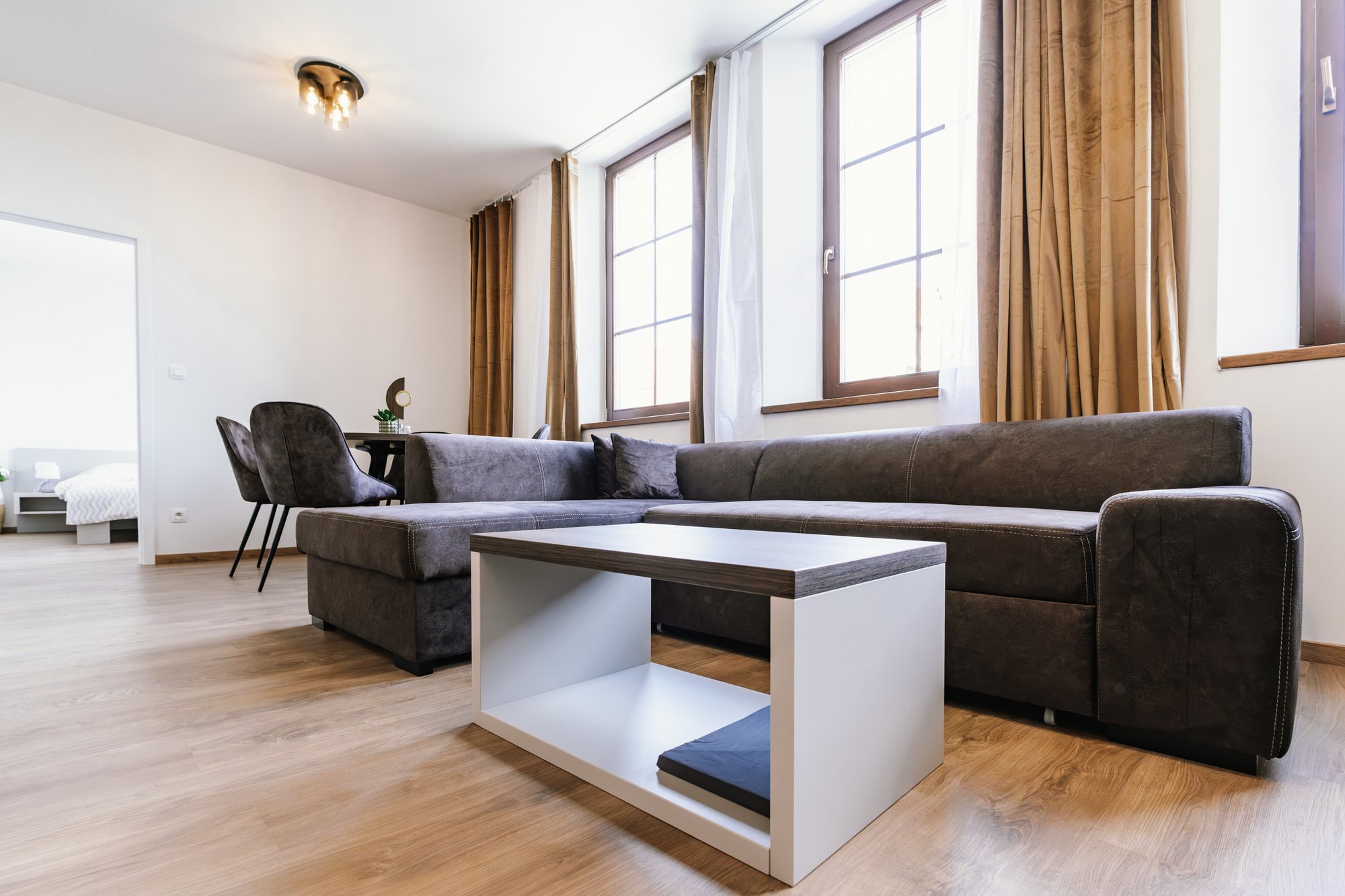 A Cashmere Grey seating set with a coffee table combining white and Brown Warmia Walnut, Bratislava.